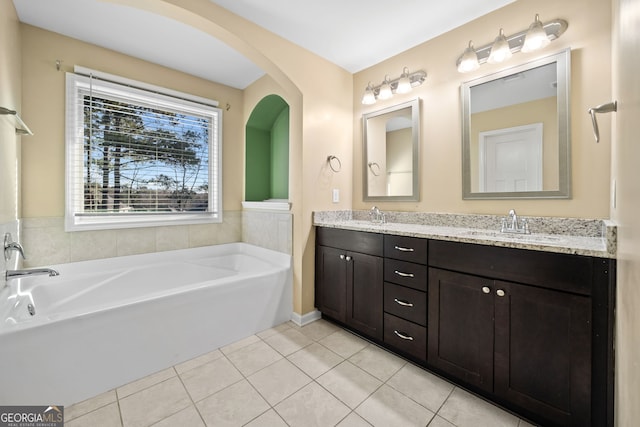 bathroom featuring a washtub, tile patterned flooring, and vanity