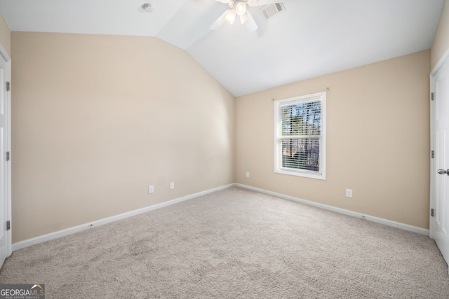 unfurnished bedroom featuring ceiling fan, carpet flooring, and vaulted ceiling