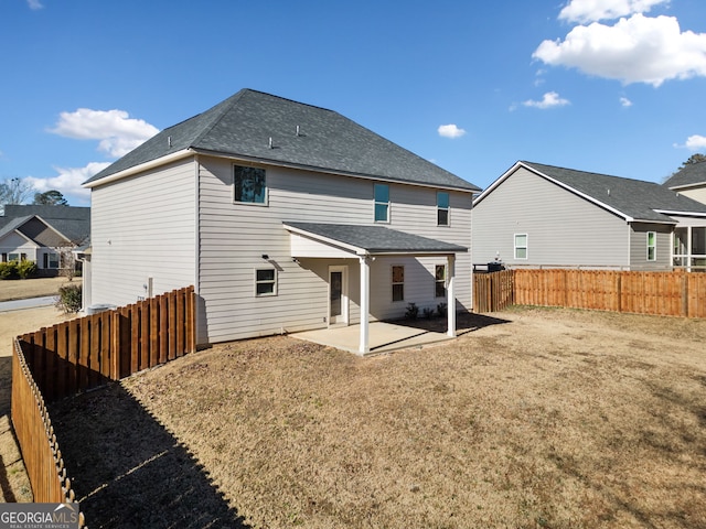 rear view of property with a patio area and a lawn