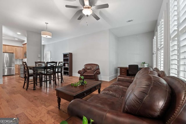 living room featuring light hardwood / wood-style flooring and ceiling fan