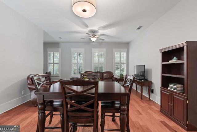 dining area with a healthy amount of sunlight, ceiling fan, and light hardwood / wood-style floors