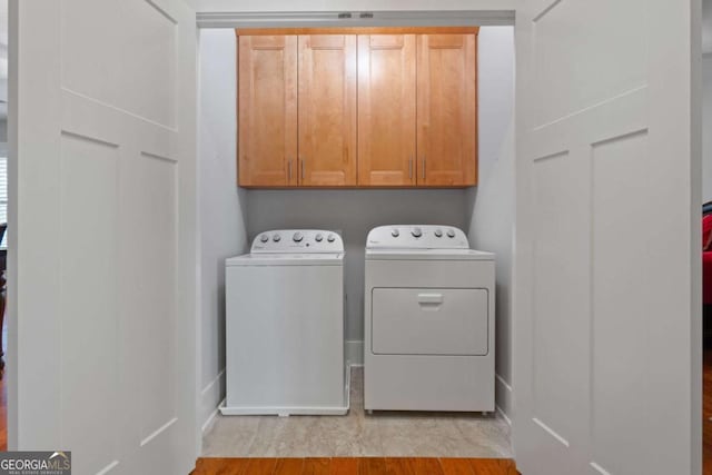 washroom featuring washer and dryer and cabinets