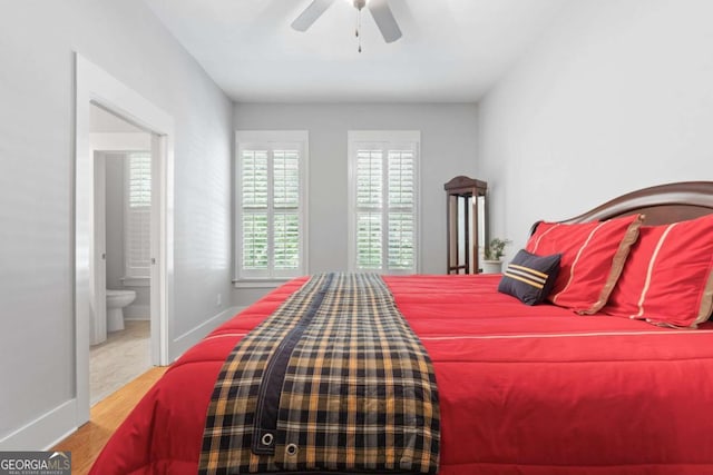 bedroom with ensuite bathroom, light hardwood / wood-style flooring, and ceiling fan