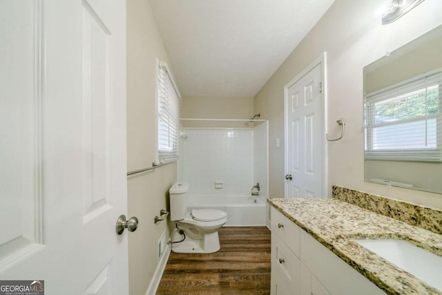 full bathroom with hardwood / wood-style floors, vanity, shower / bathtub combination, and toilet