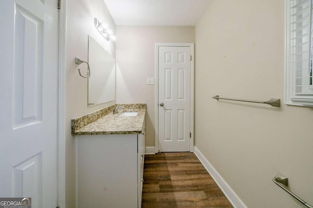 bathroom with hardwood / wood-style floors and vanity