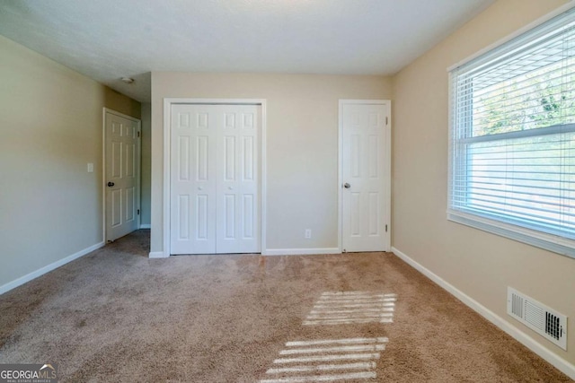 unfurnished bedroom with light carpet