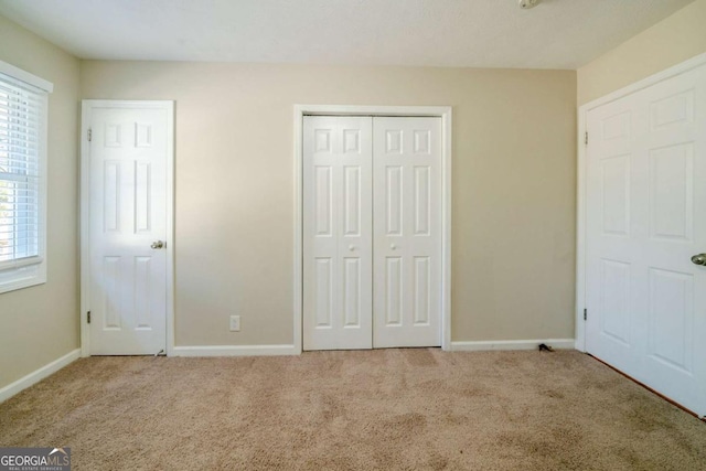 unfurnished bedroom featuring light colored carpet