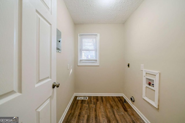 laundry room with hookup for an electric dryer, hookup for a washing machine, a textured ceiling, and dark wood-type flooring