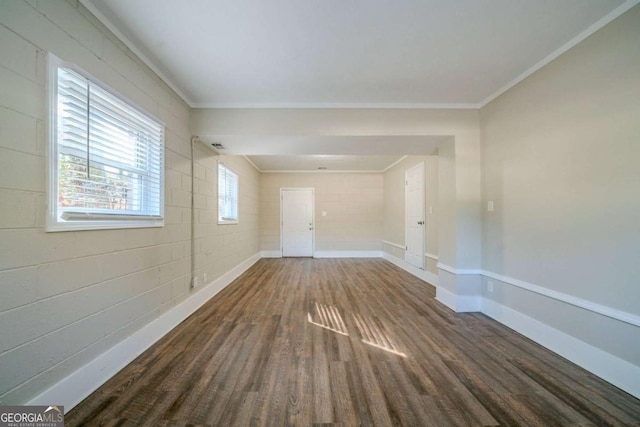 empty room featuring dark hardwood / wood-style flooring and crown molding