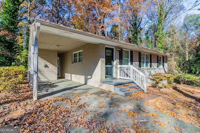 ranch-style house featuring a carport