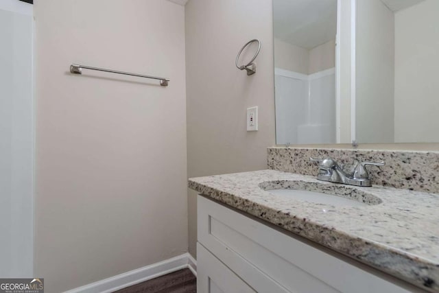 bathroom with hardwood / wood-style floors and vanity