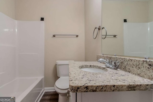 full bathroom featuring vanity, toilet, wood-type flooring, and shower / washtub combination