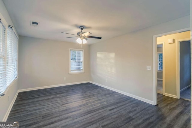 unfurnished room with ceiling fan and dark hardwood / wood-style flooring