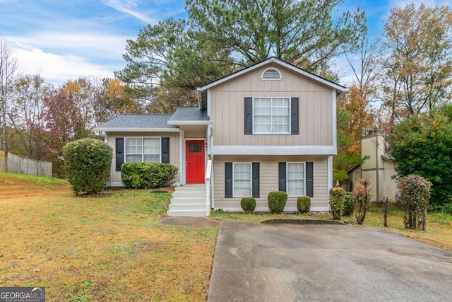 split level home featuring a front lawn