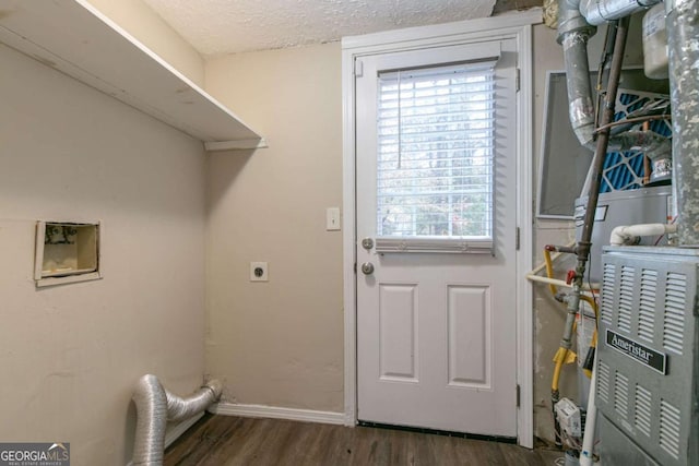 laundry room with hookup for an electric dryer, dark wood-type flooring, and a textured ceiling