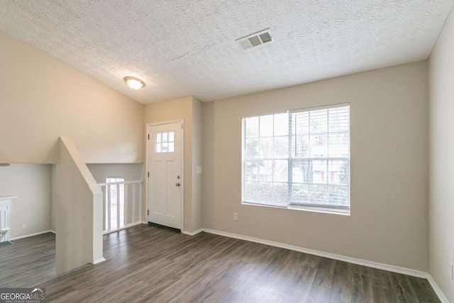 entryway featuring dark hardwood / wood-style flooring and a textured ceiling