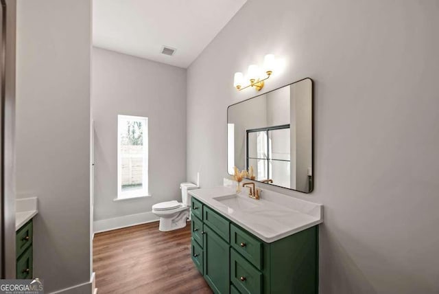 bathroom with vanity, hardwood / wood-style floors, and toilet