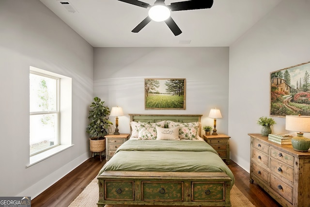 bedroom with dark hardwood / wood-style floors and ceiling fan