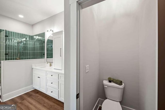 bathroom featuring vanity, hardwood / wood-style flooring, and toilet