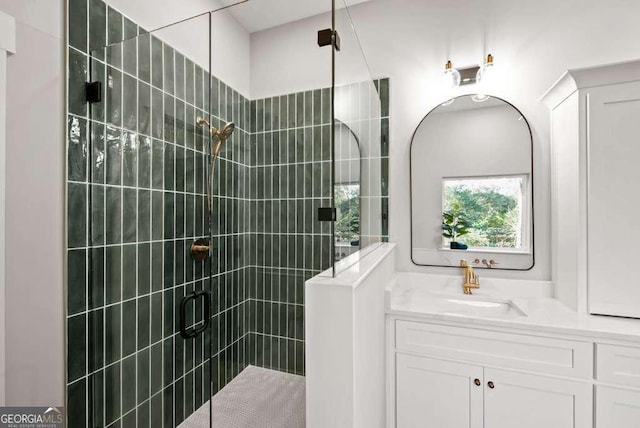 bathroom with vanity and a shower with shower door