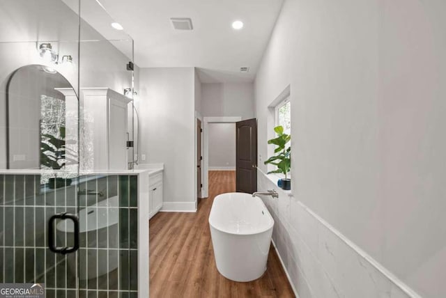 bathroom with vanity, separate shower and tub, and hardwood / wood-style floors