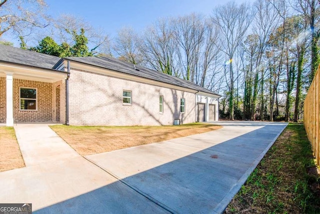 view of property exterior featuring a garage and a lawn