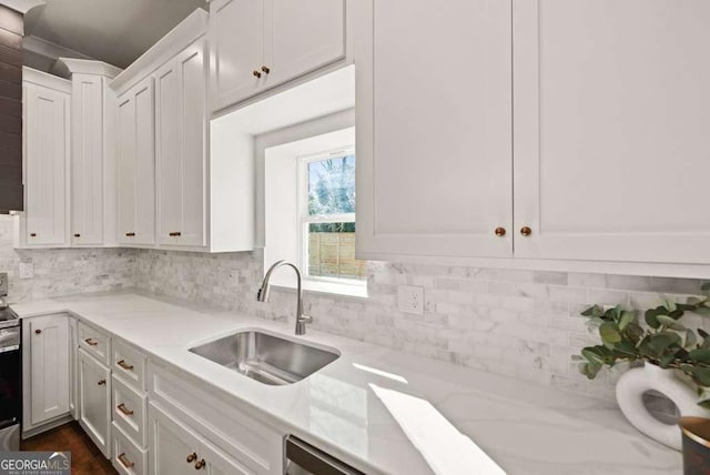 kitchen with white cabinetry, sink, decorative backsplash, electric range, and light stone countertops