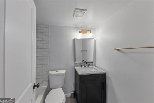 bathroom featuring vanity and toilet