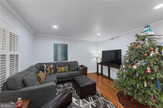 living room with wood-type flooring and crown molding