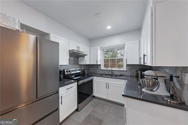 kitchen with decorative backsplash, appliances with stainless steel finishes, white cabinetry, and sink