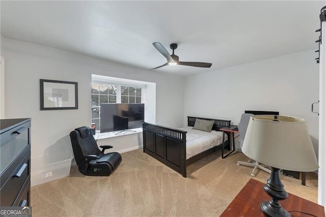 bedroom featuring ceiling fan and light carpet