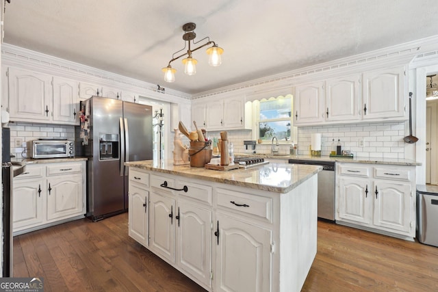 kitchen featuring white cabinetry, a kitchen island, and stainless steel appliances