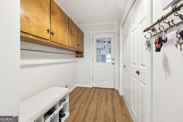 mudroom featuring light hardwood / wood-style flooring and ornamental molding