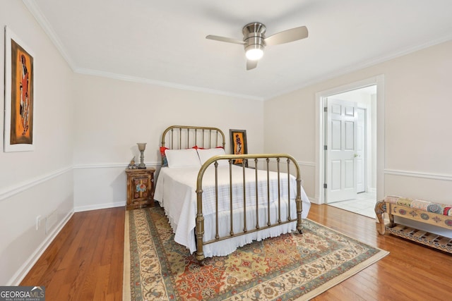 bedroom featuring ceiling fan, crown molding, and hardwood / wood-style flooring