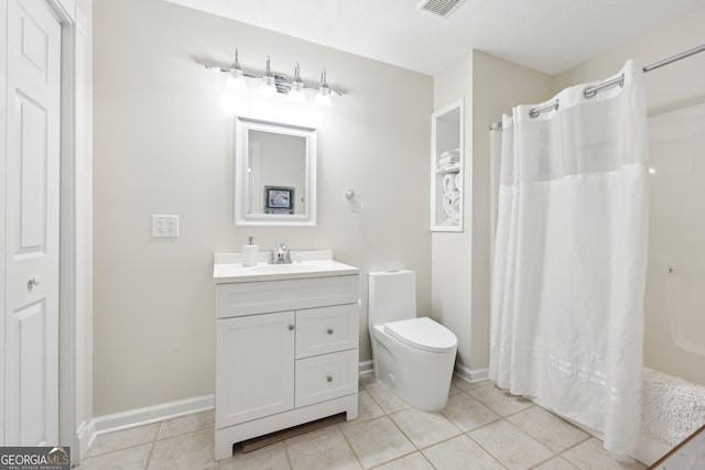 bathroom featuring tile patterned floors, curtained shower, vanity, and toilet