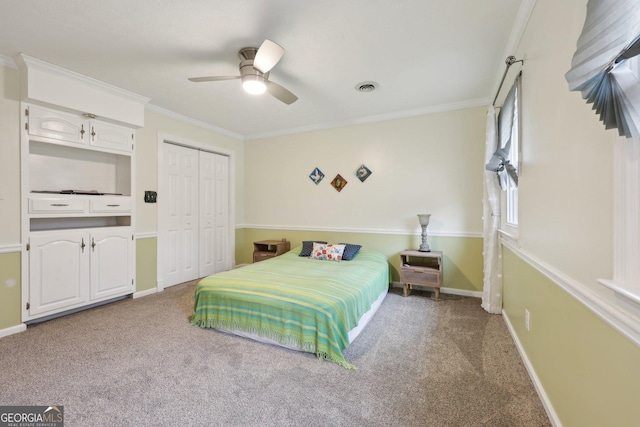 carpeted bedroom featuring a closet, ceiling fan, and ornamental molding