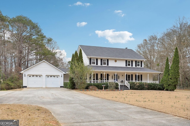 view of front of home with an outbuilding, a porch, a garage, and a front lawn