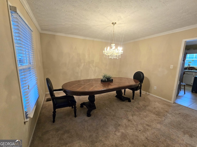 dining area with a chandelier, a textured ceiling, crown molding, and carpet flooring