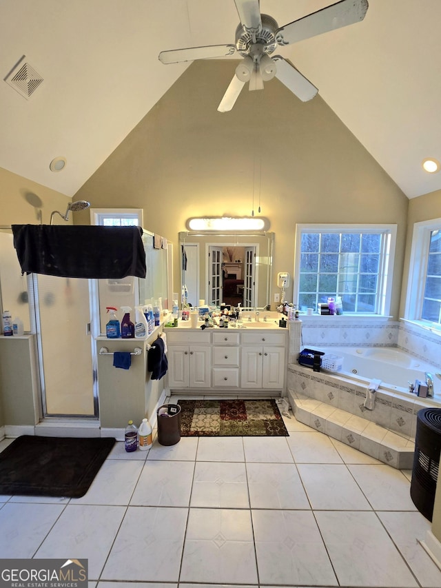 bathroom with tile patterned flooring, vanity, a healthy amount of sunlight, and high vaulted ceiling