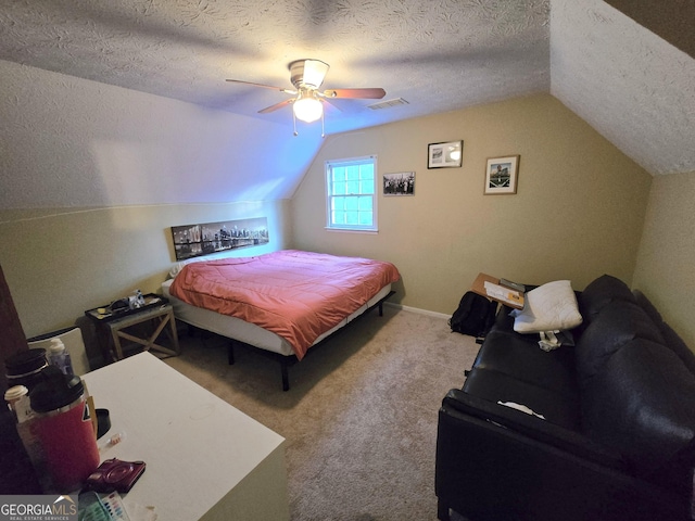 carpeted bedroom with a textured ceiling, ceiling fan, and lofted ceiling