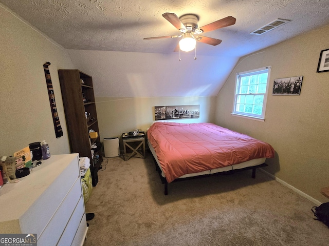 bedroom featuring ceiling fan, light colored carpet, lofted ceiling, and a textured ceiling