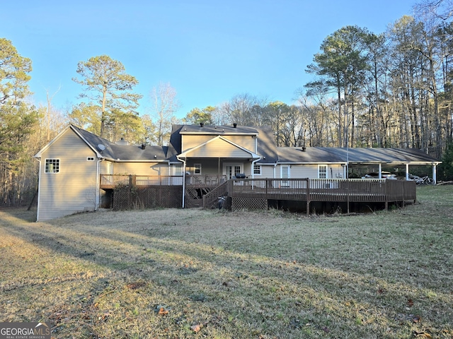 rear view of property with a yard and a wooden deck