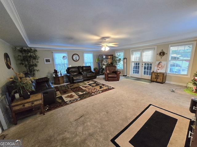 unfurnished living room featuring carpet floors, ceiling fan, and ornamental molding