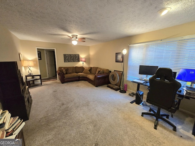 living room featuring carpet flooring, ceiling fan, and a textured ceiling