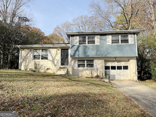 tri-level home with a front lawn and a garage