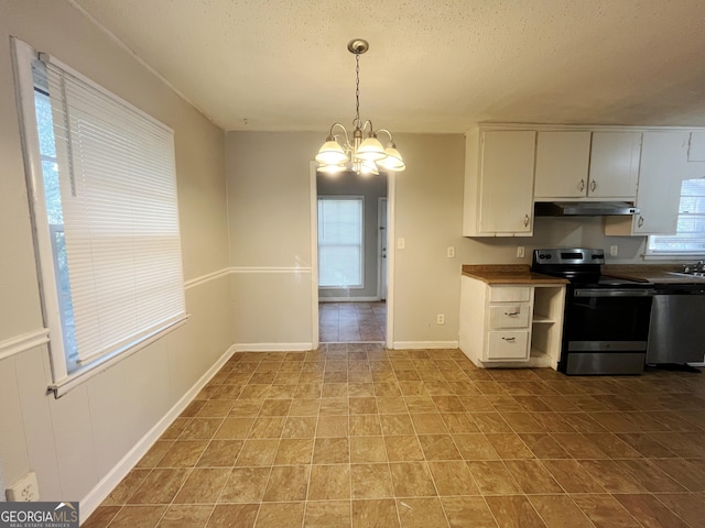 kitchen with stainless steel appliances, a healthy amount of sunlight, a textured ceiling, an inviting chandelier, and decorative light fixtures