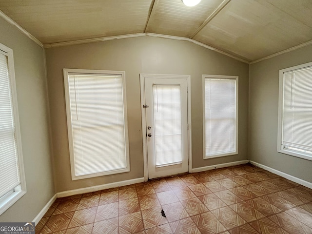 entryway with lofted ceiling and crown molding