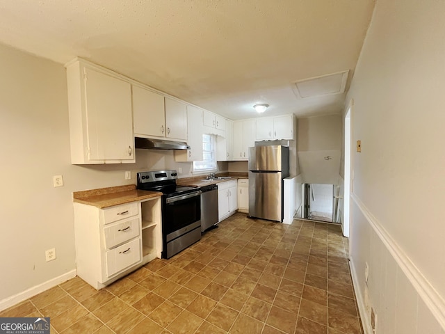 kitchen with appliances with stainless steel finishes, white cabinetry, and sink