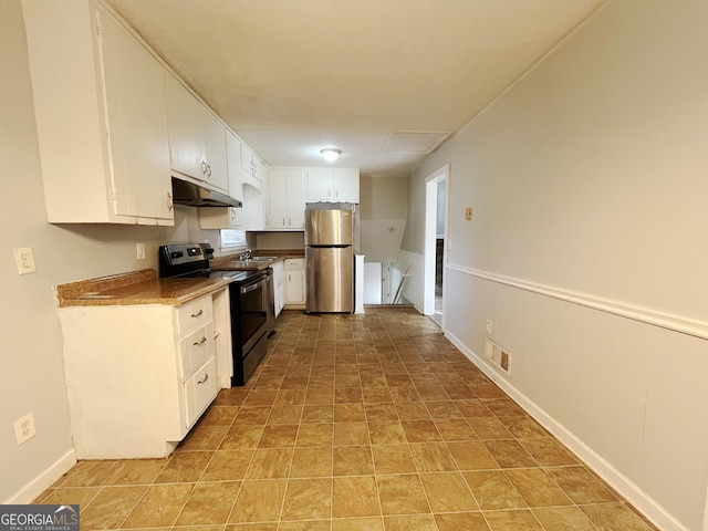 kitchen featuring electric range, white cabinets, sink, and stainless steel refrigerator