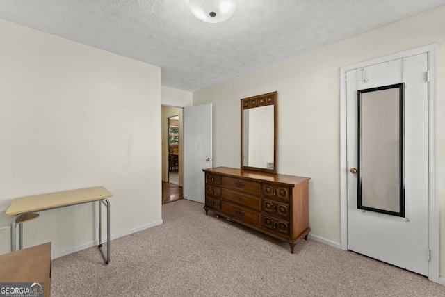 carpeted bedroom with a textured ceiling